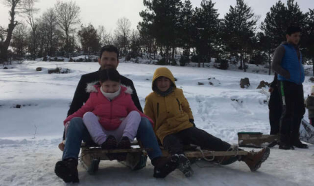 Bursa'da tahta kızak ve naylonlarla kar keyfi